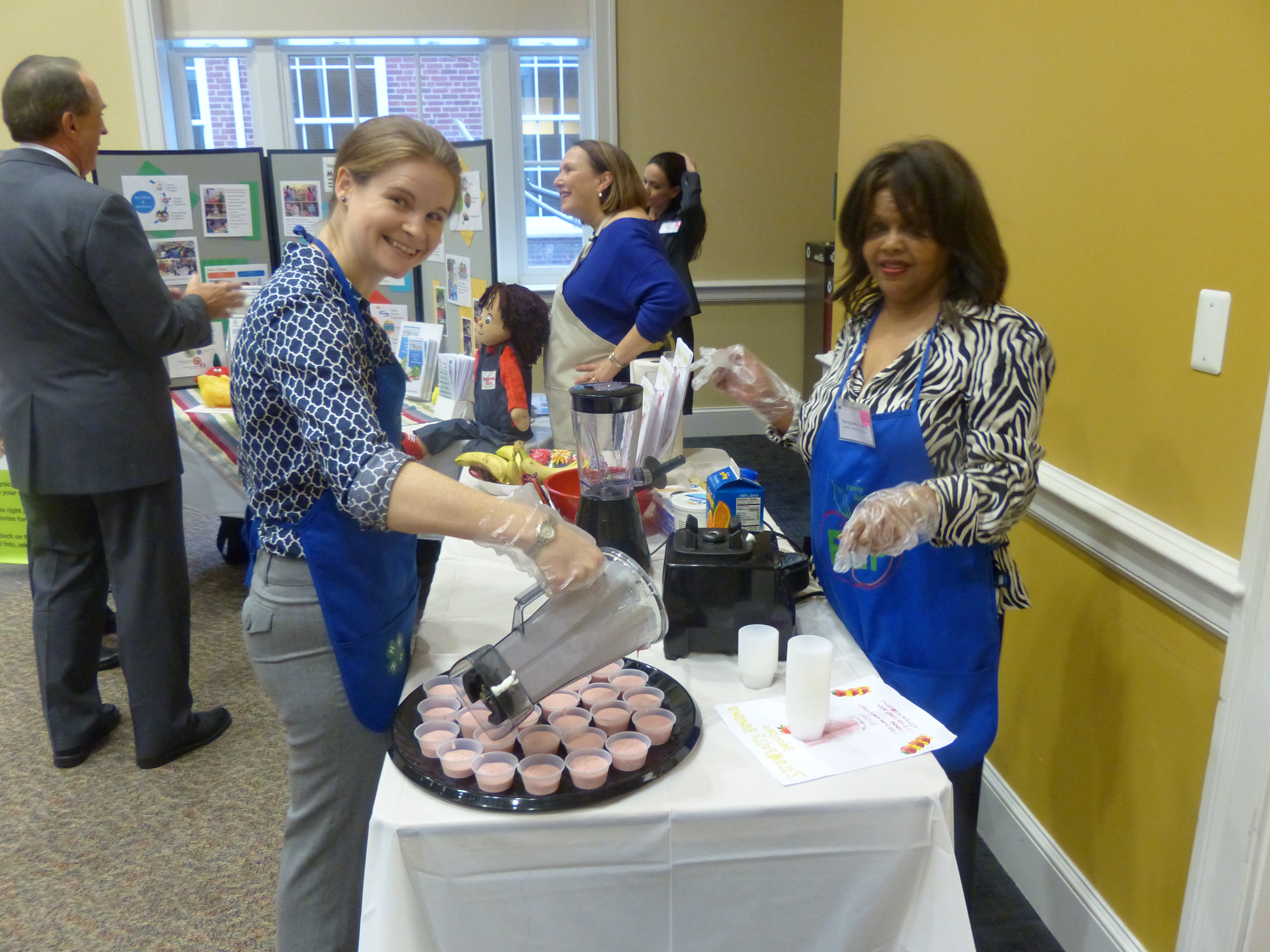 Staff Megan Mauer and Haregowoin Tecklu prepare healthy smoothies to share with visitors